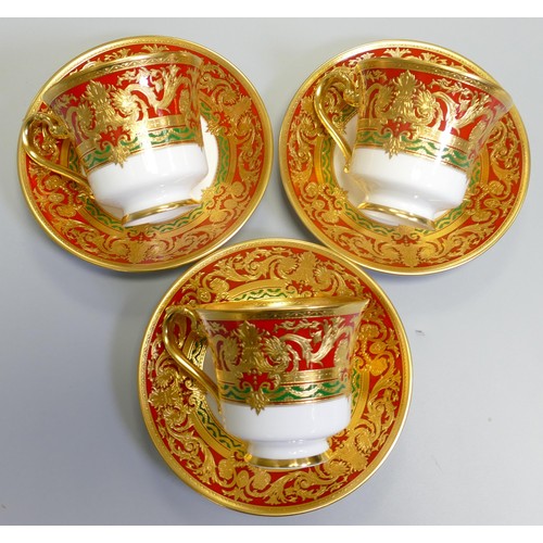 1010 - De Lamerie Fine Bone China heavily gilded Red/ Green Empress patterned cup / saucer sets, specially ... 