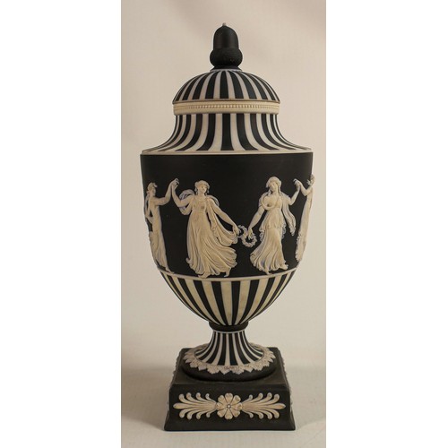 1056 - Wedgwood black & white Jasperware urn & cover decorated in the dancing hours design dated, height 25... 