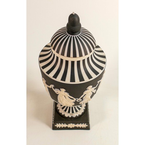 1056 - Wedgwood black & white Jasperware urn & cover decorated in the dancing hours design dated, height 25... 