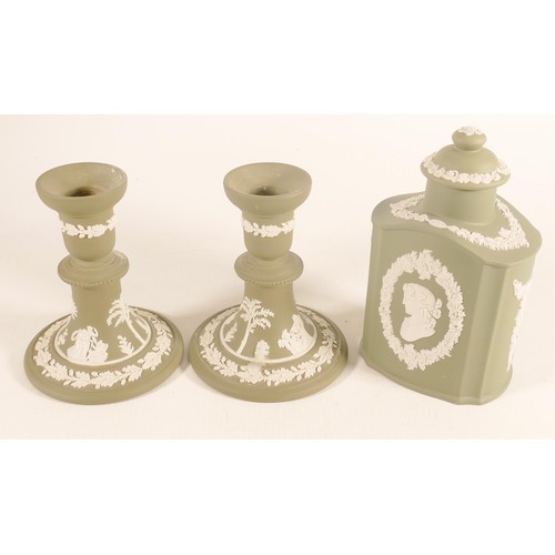 1110 - Wedgwood sage green candlesticks & tea caddy, height of tallest 16.5cm. (3)