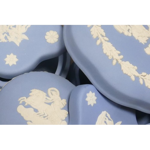 1147 - A collection of Wedgwood blue Jasper ware to include - large footed bowl, lidded pots, pin trays etc... 