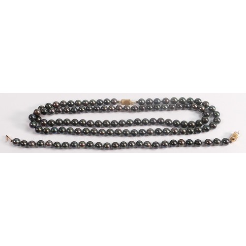 1929 - String of black cultured pearls, together with matching bracelet, catches are both stamped 14ct gold... 