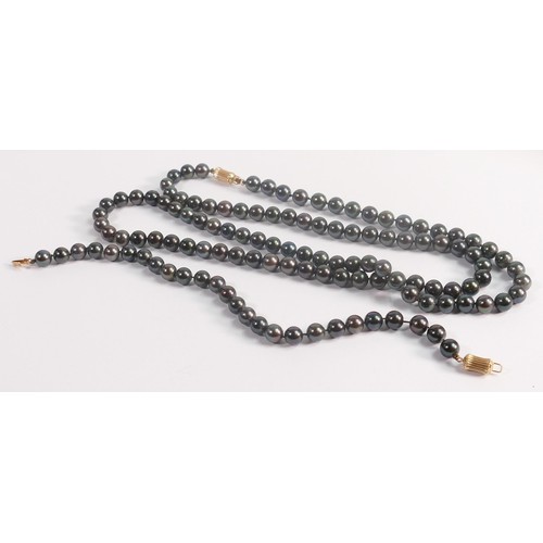 1929 - String of black cultured pearls, together with matching bracelet, catches are both stamped 14ct gold... 