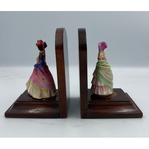 653 - A pair of early Royal Doulton Figural book ends (a/f)