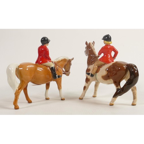 240 - Beswick girl on Skewbald pony 1499, together with a boy on pony 1500. Both with red jackets. Girl on... 