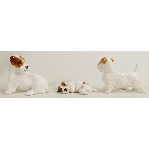 399 - A collection of Royal Doulton character dogs comprising dog looking back HN2508, dog curled up and d... 