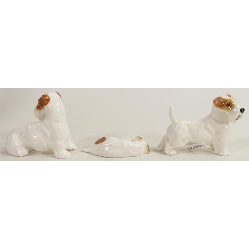 399 - A collection of Royal Doulton character dogs comprising dog looking back HN2508, dog curled up and d... 