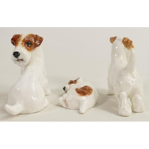 399 - A collection of Royal Doulton character dogs comprising dog looking back HN2508, dog curled up and d... 