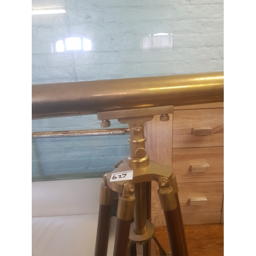 627 - Large brass telescope on brass bound mahogany tripod support, length of telescope 162cm.