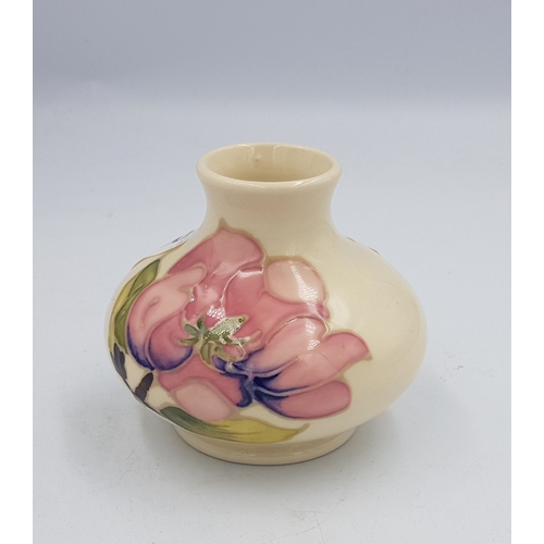 303 - Moorcroft pink magnolia on cream ground small squat vase, 7cm in height.