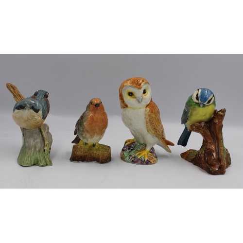 484 - A collection of bird figures to include Beswick 2026 Owl, Coalport Blue Tit and Robin and a Wedgwood... 