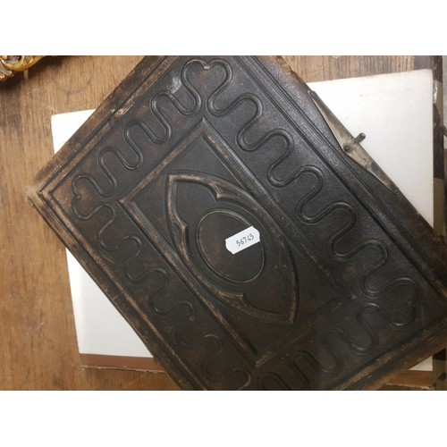 77 - A Victorian leather bound photo album (front cover detached but present).