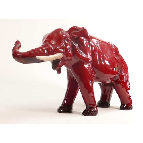 386 - Royal Doulton large Flambe model of an elephant with white tusks, h.28cm, a/f. End of trunk re-stuck... 