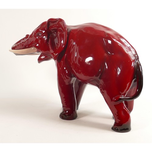 386 - Royal Doulton large Flambe model of an elephant with white tusks, h.28cm, a/f. End of trunk re-stuck... 