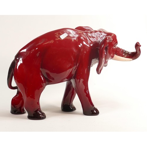 386 - Royal Doulton large Flambe model of an elephant with white tusks, h.28cm, a/f. End of trunk re-stuck... 