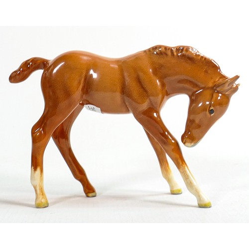 654 - Beswick head down foal 947 in chestnut gloss. One back leg with good restoration.