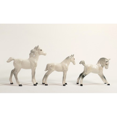 656 - A collection of Beswick grey foals, comprising Thoroughbred foal 1813, facing left 1084 and grazing ... 