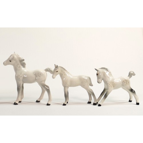 656 - A collection of Beswick grey foals, comprising Thoroughbred foal 1813, facing left 1084 and grazing ... 