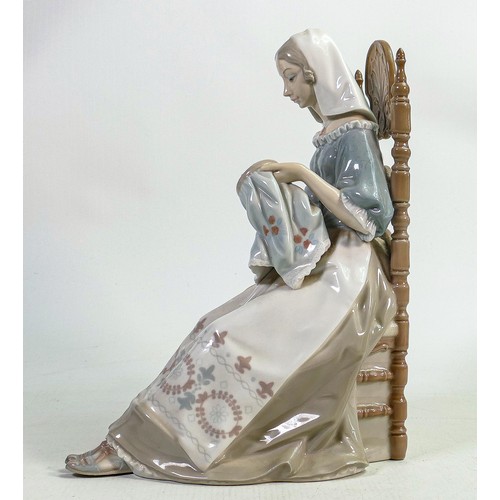 827 - Lladro lady seated in chair with embroidery stately figurine, height 27cm