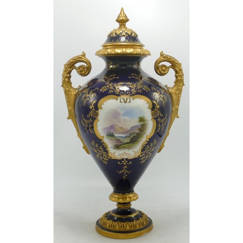 865 - Coalport large two handled gilded vase with panel of Ullswater landscape, - finial re-stuck with chi... 