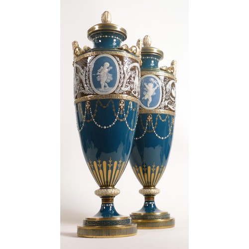 884 - A stunning pair of Minton two handled Pate-sur-Pate vase & covers, gilded and decorated with cupids ... 