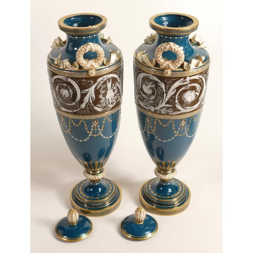 884 - A stunning pair of Minton two handled Pate-sur-Pate vase & covers, gilded and decorated with cupids ... 