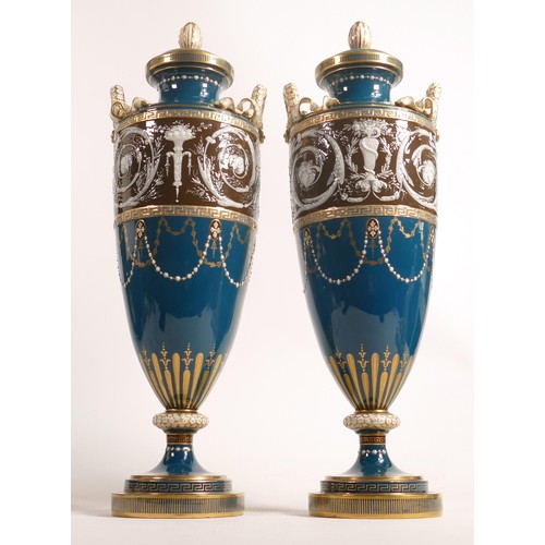 884 - A stunning pair of Minton two handled Pate-sur-Pate vase & covers, gilded and decorated with cupids ... 