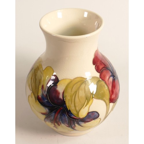 909 - Walter Moorcroft vase decorated in the hibiscus design on cream ground, h.24.5cm, good condition wit... 