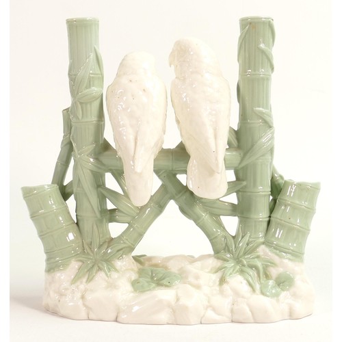 949 - Royal Worcester Aesthetic period green and white spill vase, in the form of two love birds perched o... 