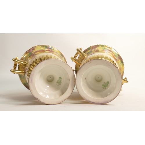 983 - Superb pair of Royal Worcester two handled urns, gilded and hand painted with fruit by J Smith, h.22... 