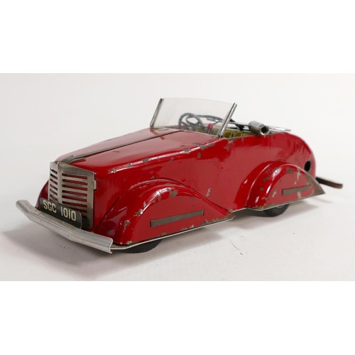 1666 - Louis Marx Toby Toys red sports car, c1950s, reg SGC1010, with key, working order, L.36.5cm. Played ... 