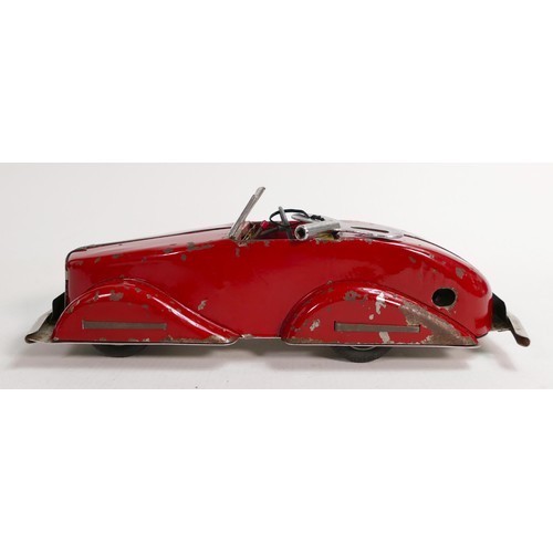 1666 - Louis Marx Toby Toys red sports car, c1950s, reg SGC1010, with key, working order, L.36.5cm. Played ... 