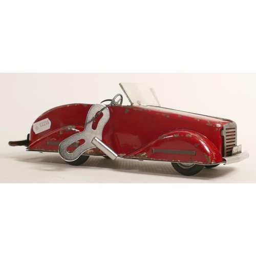 1666 - Louis Marx Toby Toys red sports car, c1950s, reg SGC1010, with key, working order, L.36.5cm. Played ... 