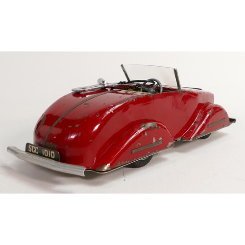 1666 - Louis Marx Toby Toys red sports car, c1950s, reg SGC1010, with key, working order, L.36.5cm. Played ... 