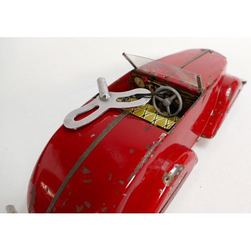 1666 - Louis Marx Toby Toys red sports car, c1950s, reg SGC1010, with key, working order, L.36.5cm. Played ... 