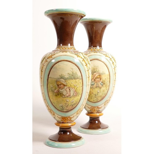 455 - A superb pair of Doulton Lambeth Faience vases by Ada Dennis, hand painted oval panels of children w... 