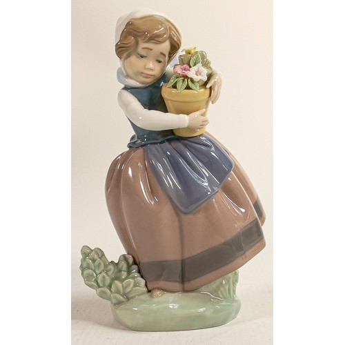 386 - Lladro figure of child holding a flower pot 5223, height 17cm.