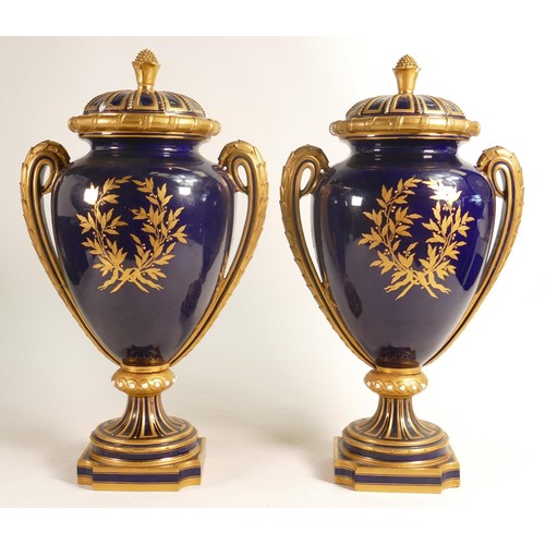 928 - A pair of Royal Worcester vase and covers,
dated 1871, each decorated with farm girls on gilded coba... 