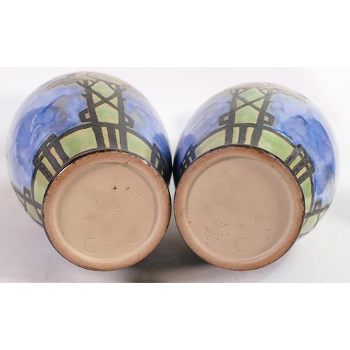 417A - Pair of Royal Doulton Lambeth vases by Eliza Simmance, both decorated all around with apples on a bl... 