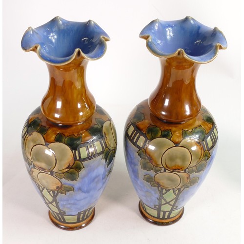 417A - Pair of Royal Doulton Lambeth vases by Eliza Simmance, both decorated all around with apples on a bl... 