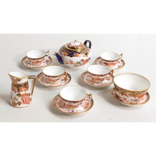 1253 - A collection of Royal Crown Derby miniature cup & saucers, decorated with various Imari designs. (7)