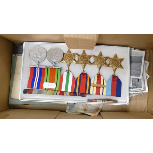 662 - A collection of medals and items belonging to a soldier, including a group of medals including Afric... 