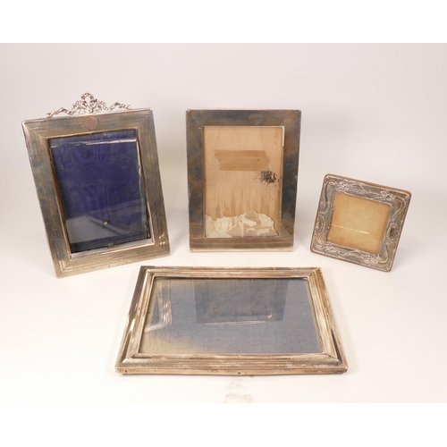 812 - 4 x silver hallmarked photo frames, the largest measuring 21.5cm x 15cm, the smallest with areas of ... 