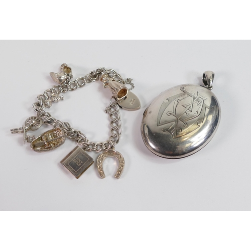 805 - Silver charm bracelet and silver large oval locket, 68.8g.