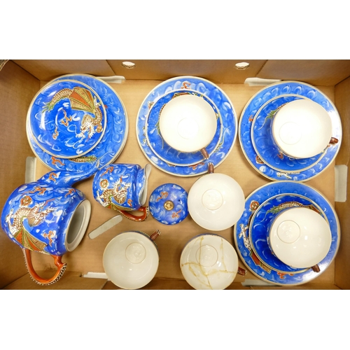 70 - A collection of Oriental Egg Shell Type teaware decorated with dragons, some damages noted