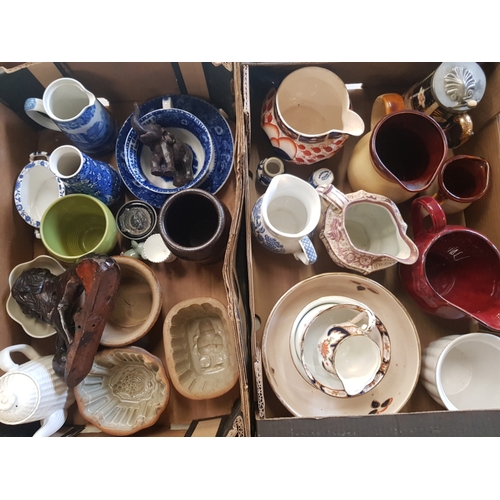 87 - A mixed collection of items to include jugs, stoneware jelly/mousse moulds, carved hardwood lion etc... 