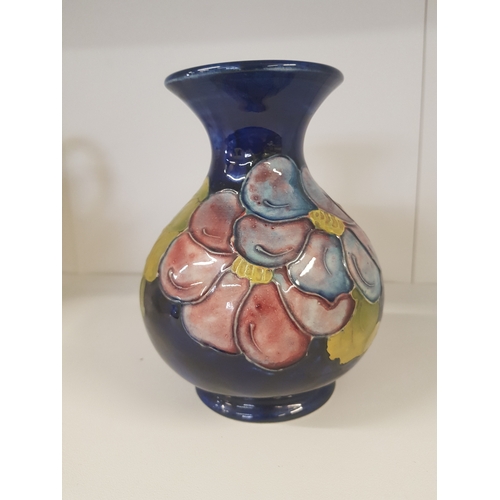 346 - Moorcroft Clematis pattern vase on blue ground Height 13cm