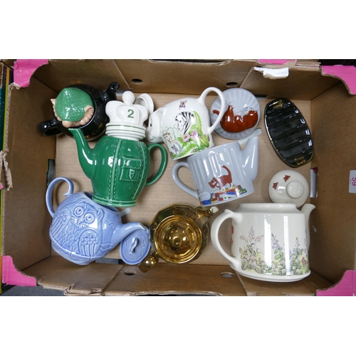 59 - A collection of Wade including Novelty Teapots, Andy Cap Teapot, Toast Rack  etc These were removed ... 