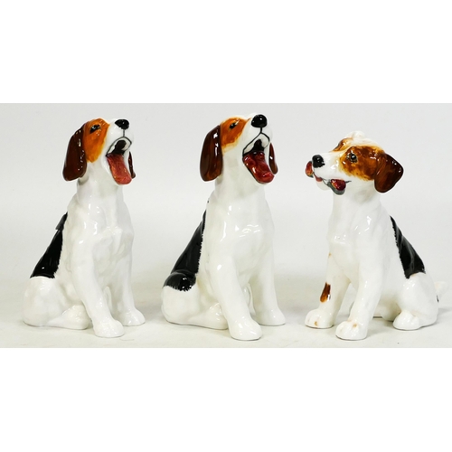 244 - Three Royal Doulton dog figures. Two yawning and one slipper in his mouth (3)