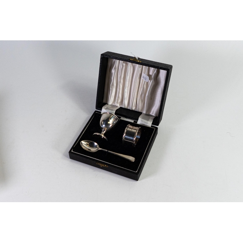 761 - Cased hallmarked silver christening set includes Egg cup spoon & napkin / serviette ring.